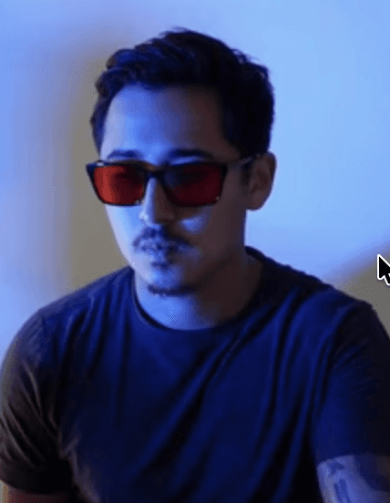 A man works on a laptop in an office.