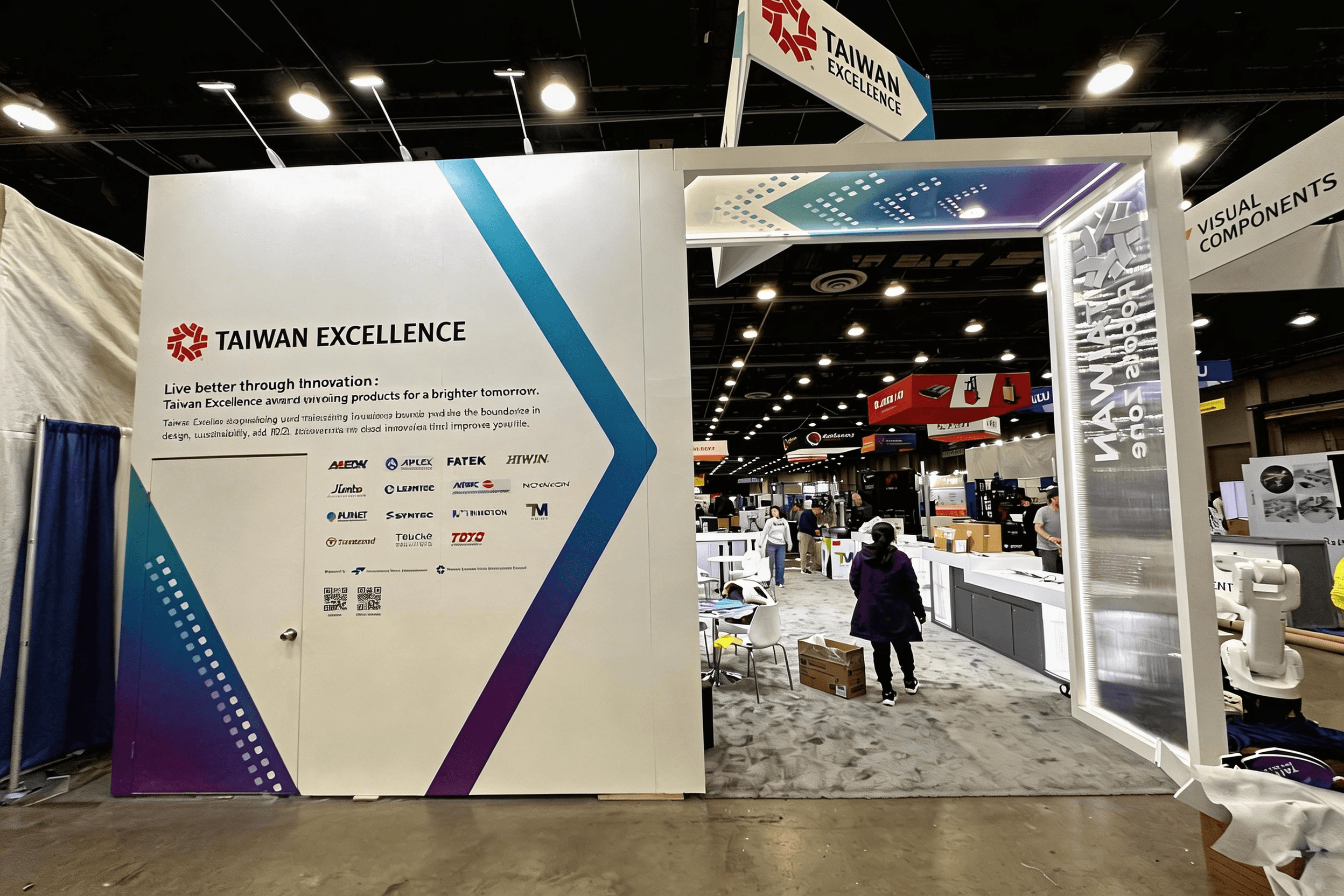 Wide view of Taiwan Excellence backwall graphics with multi-brand robotics showcase at Automate 2025.
