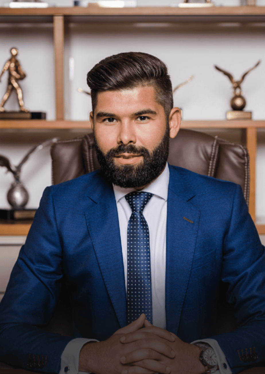 A serious smiling man dressed in a suit