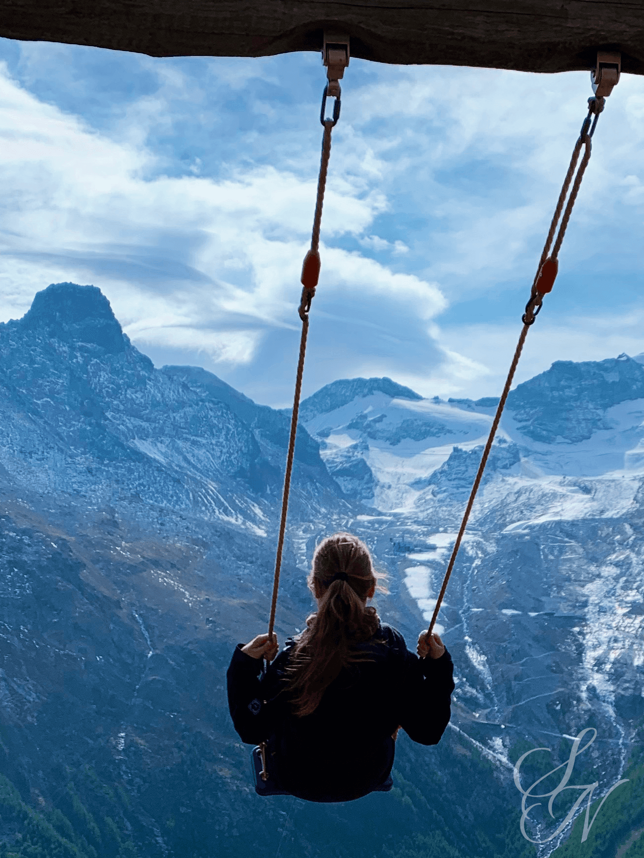 Swinging with a breathtaking mountain view above Saas-Fee in Switzerland.