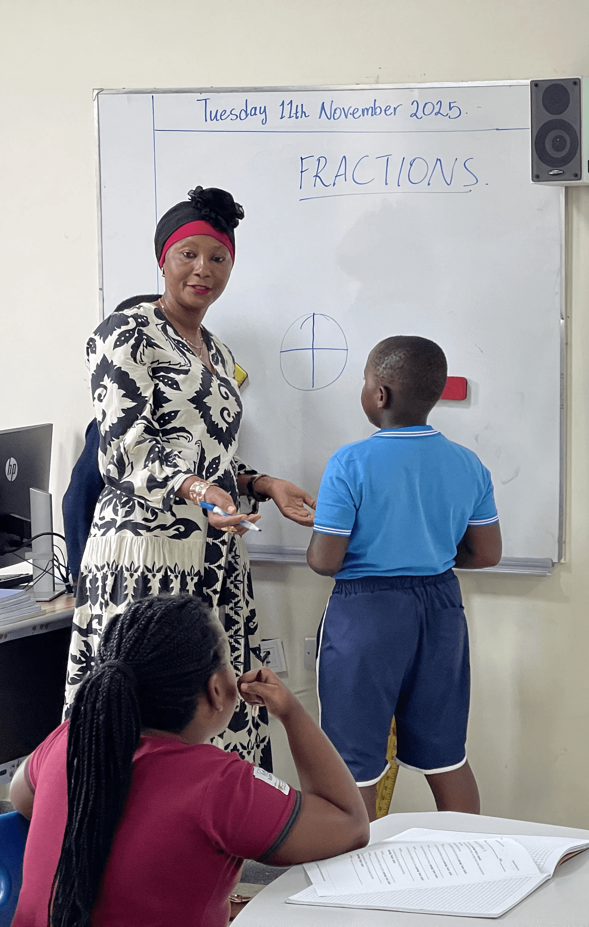 A mother and her son are sitting together, using a tablet to work on homework