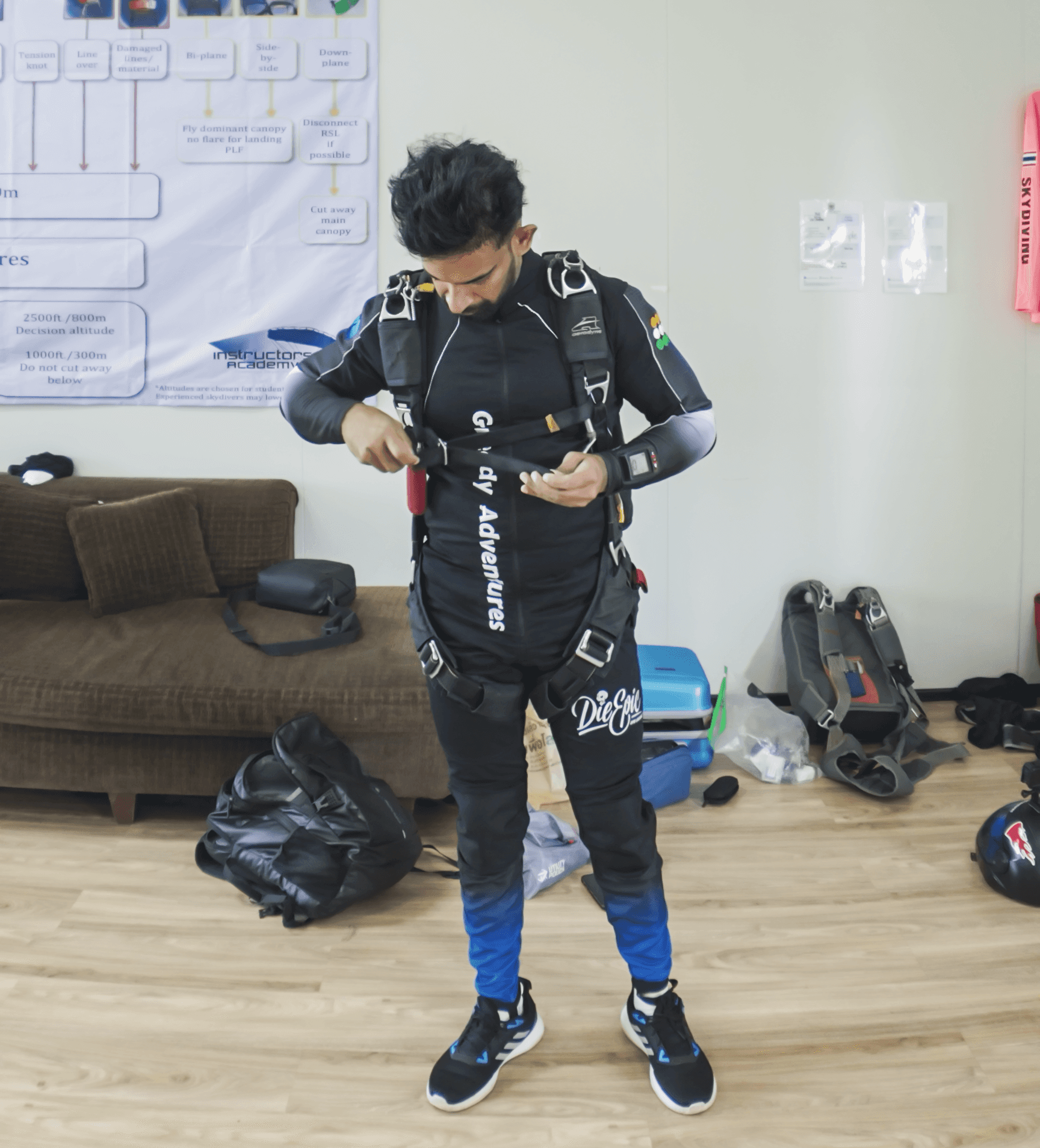 Licensed skydiver gearing up and checking equipment at dropzone