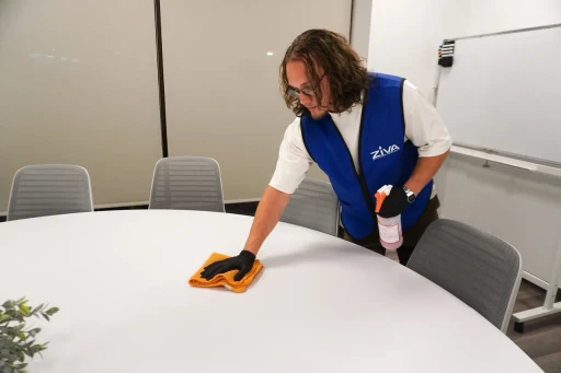 wiping office desk with Ziva Cleaning Services