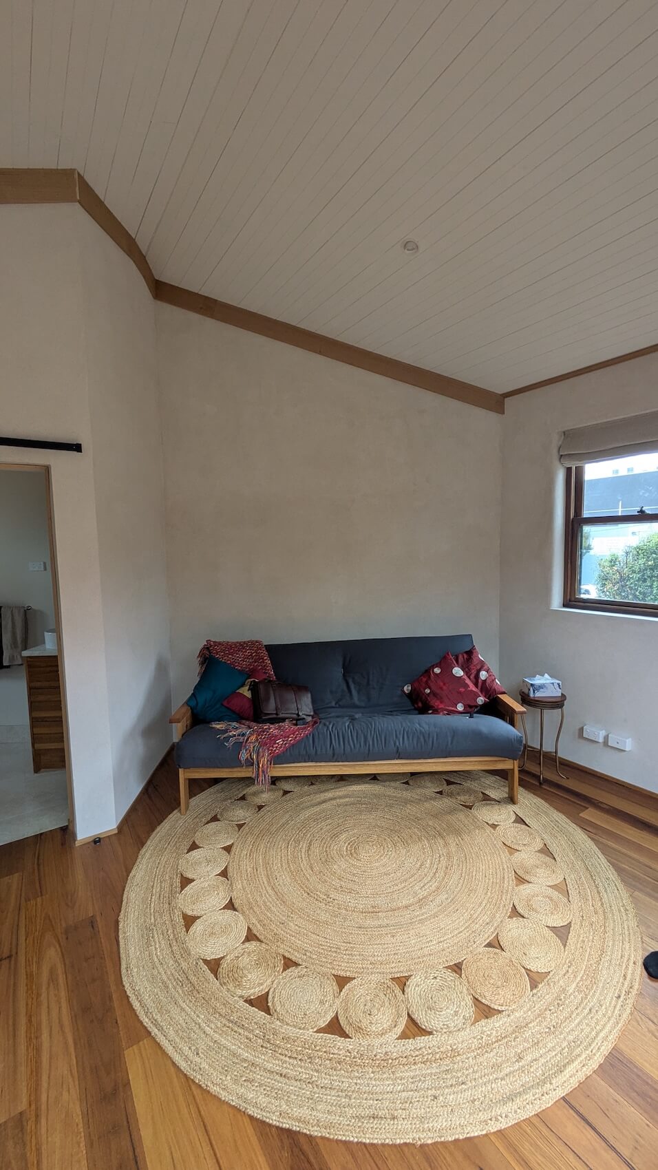 A picture of a couch in a beautiful hempcrete home built with Respirabuilt hempcrete blocks with a lime rendered wall.