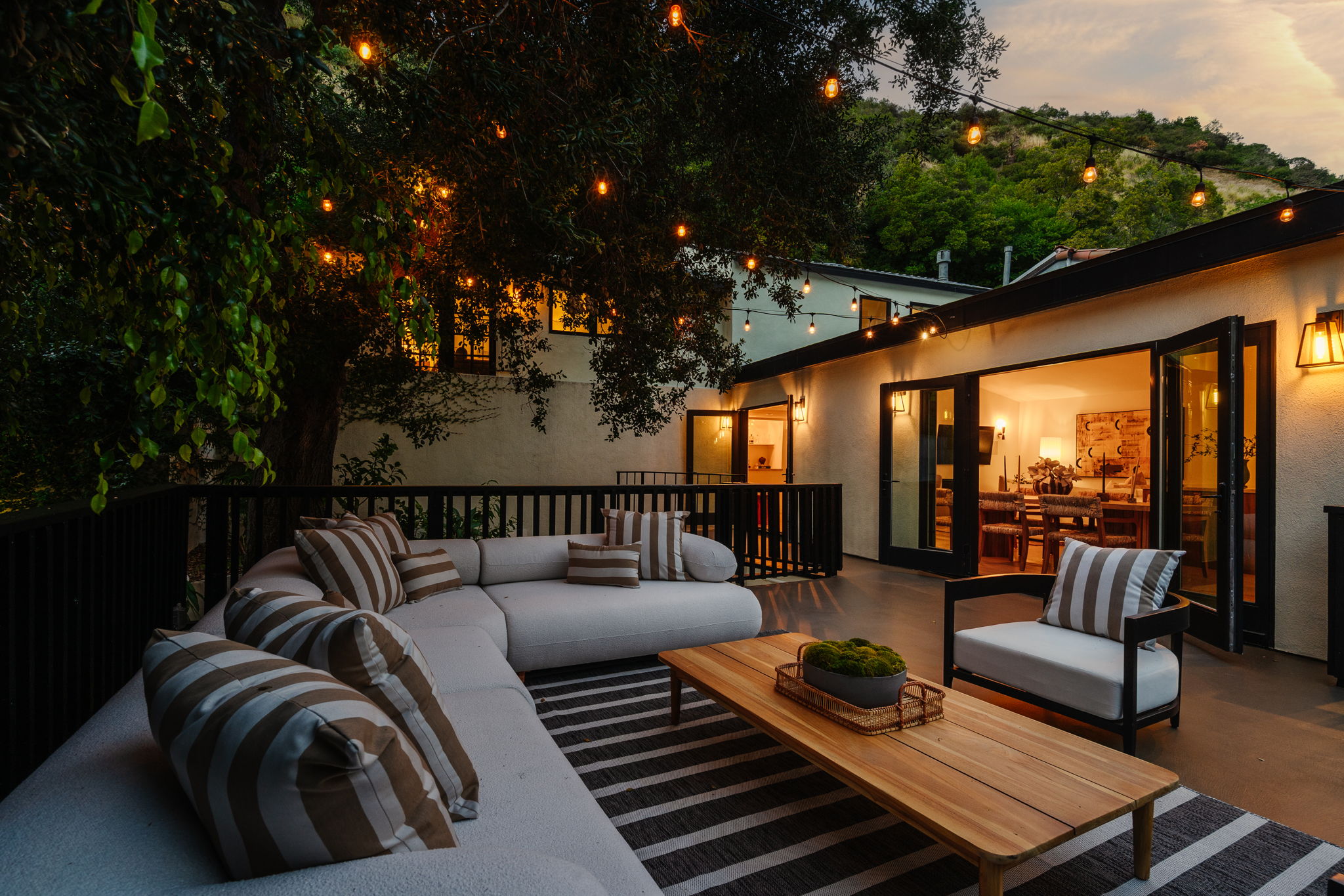 Modern hillside home with terracotta urn and mountain view