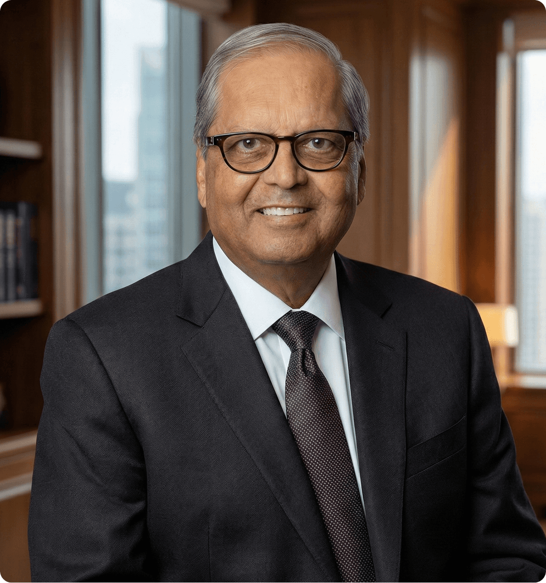 Mahen (Mike) Acharya, SteriMax Founder: Smiling in professional business attire against an office background.