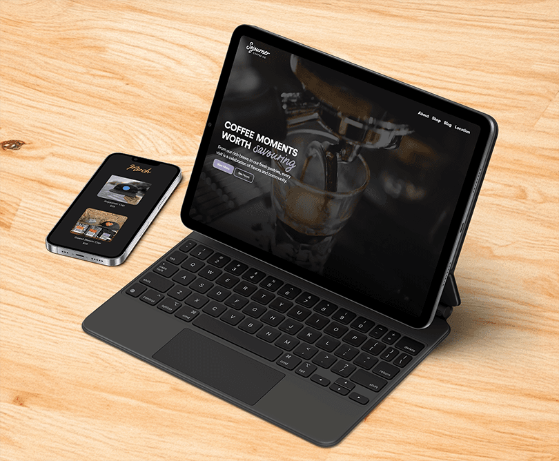 Landscape IPad with keyboard attachment and Apple pen and IPhone on on a light surface displaying website mockups