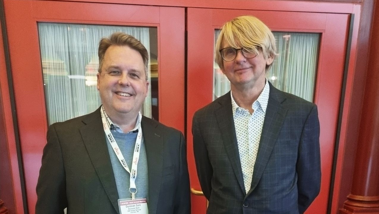 Donovan Guin from IBM and Arnulf Hagen from Aidalos, pictured standing together at the TRB 105th Annual Meeting in Washington, DC. They are both smiling at the camera.