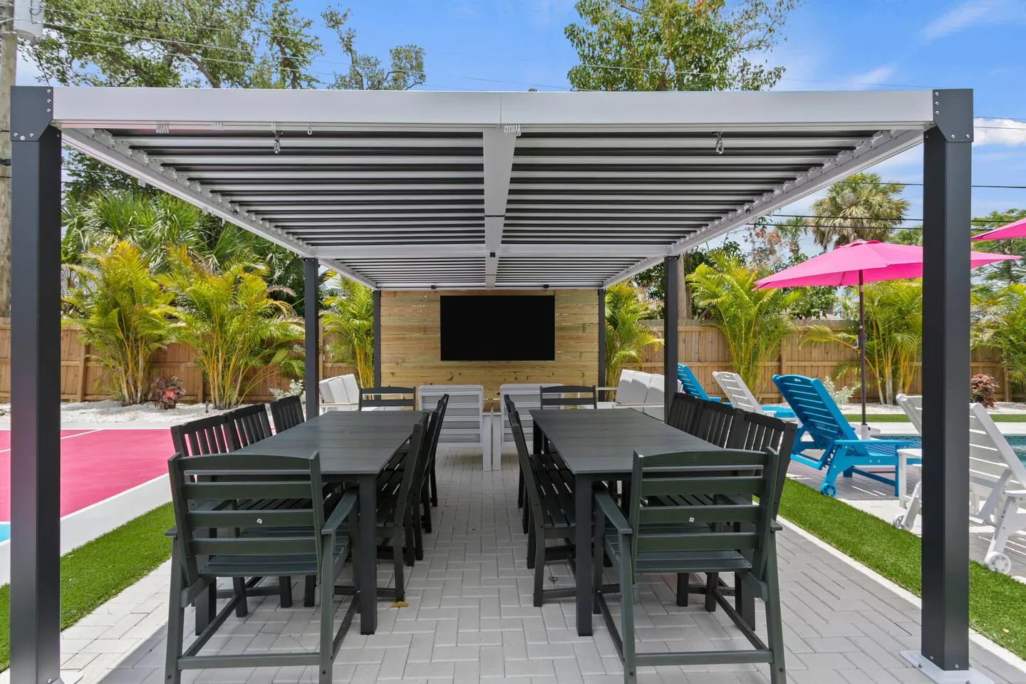 Pergola dining tables with TV at Salty House, Bradenton, Florida