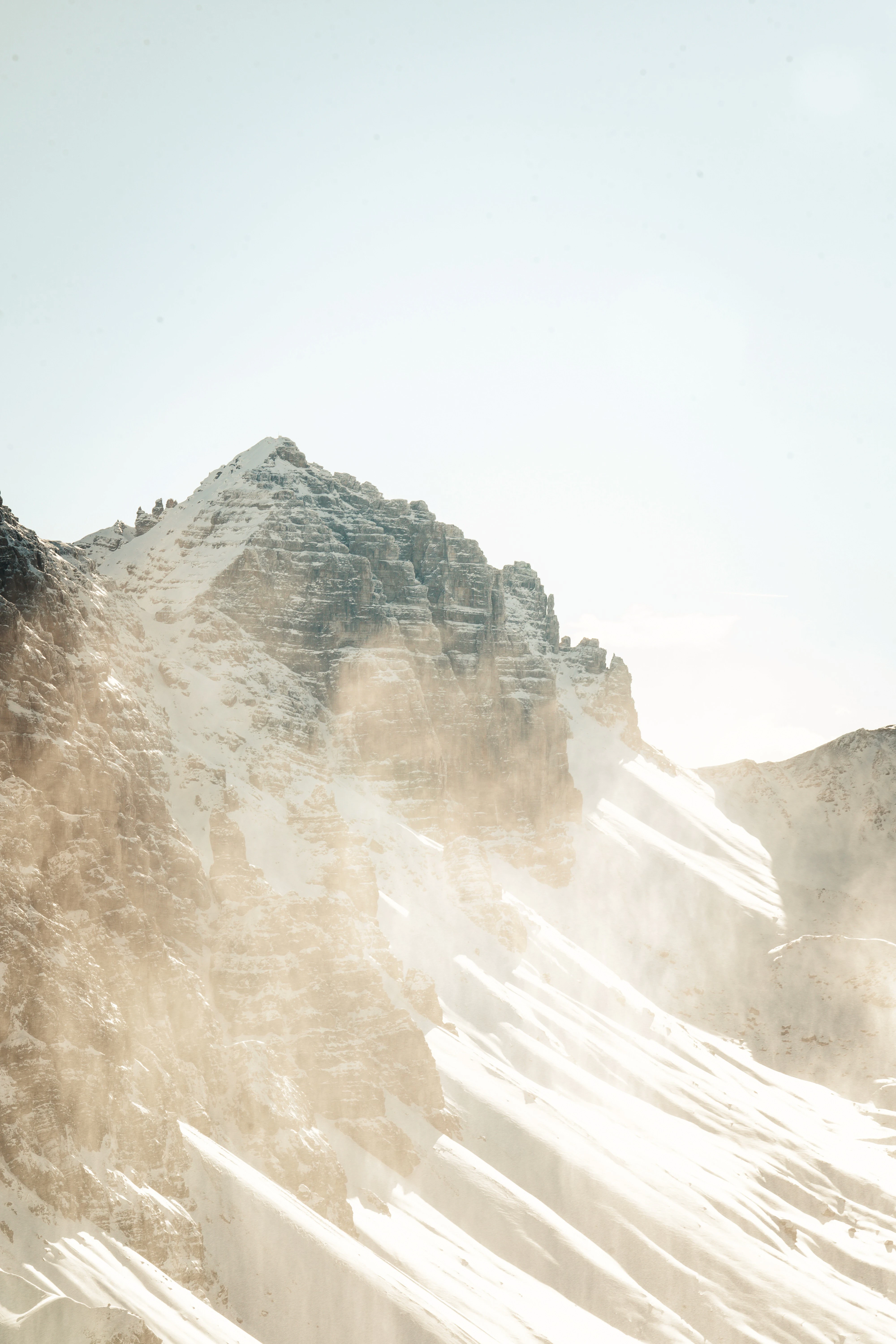 Snow-covered mountain peak with sunlight.