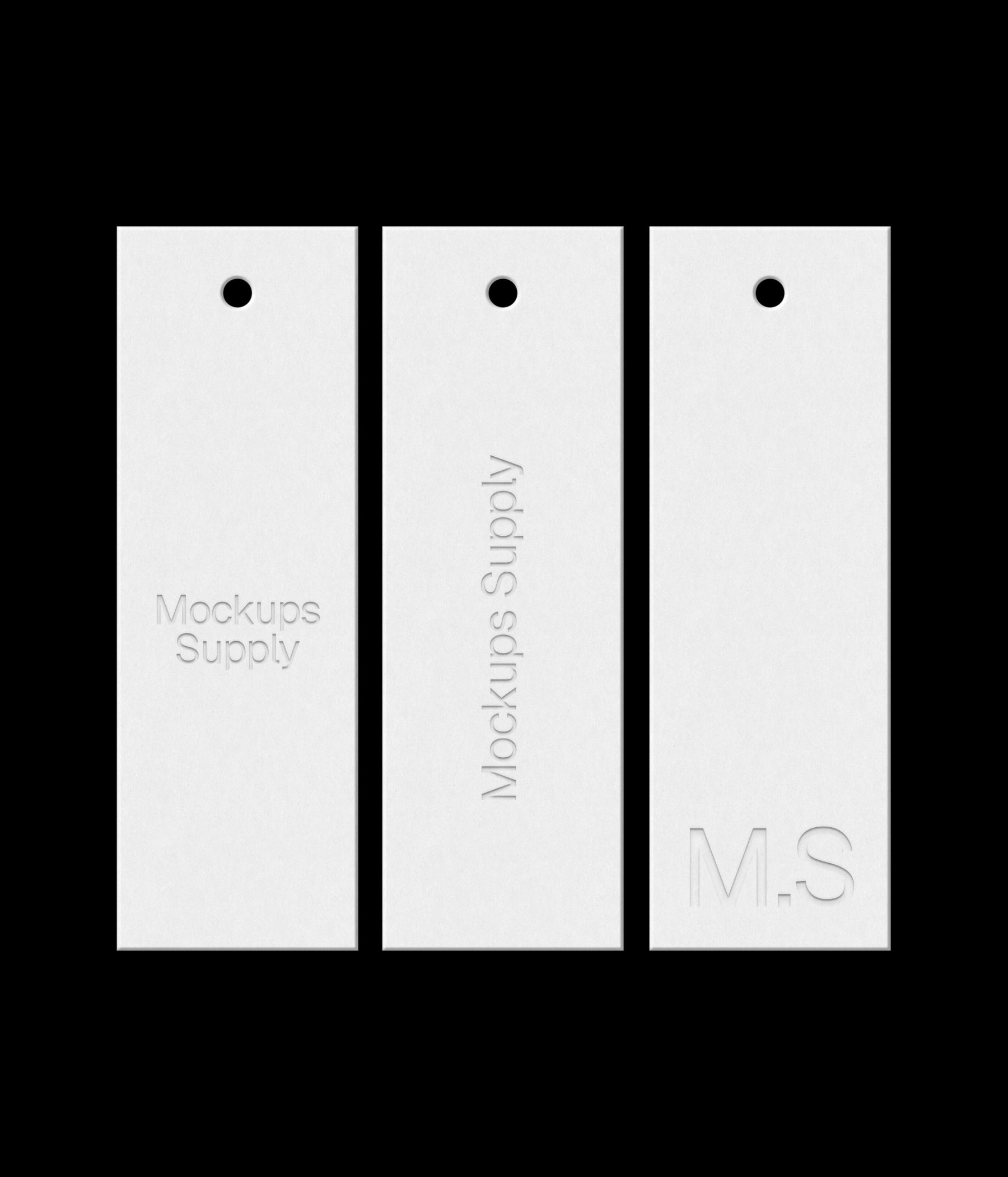 Three white 1x3 vertical hang tags mockup on black background with debossed text effect for Photoshop download psd
