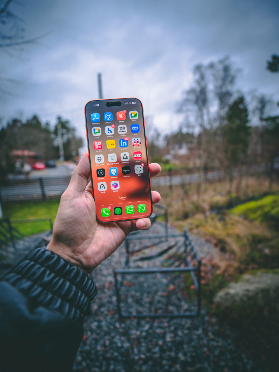 High-contrast portrait of a man looking to the side against a solid red background.
