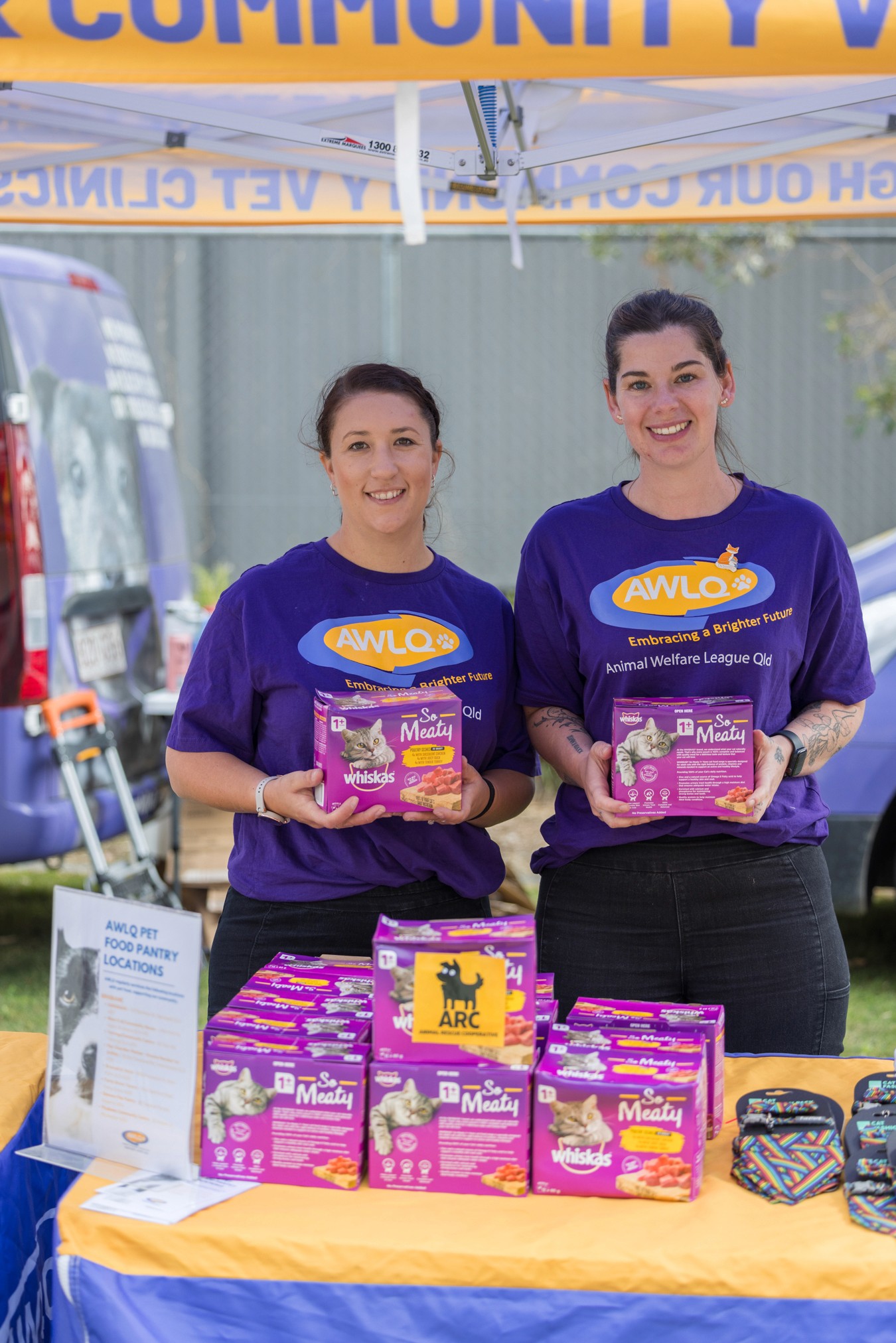Volunteers holding cat food