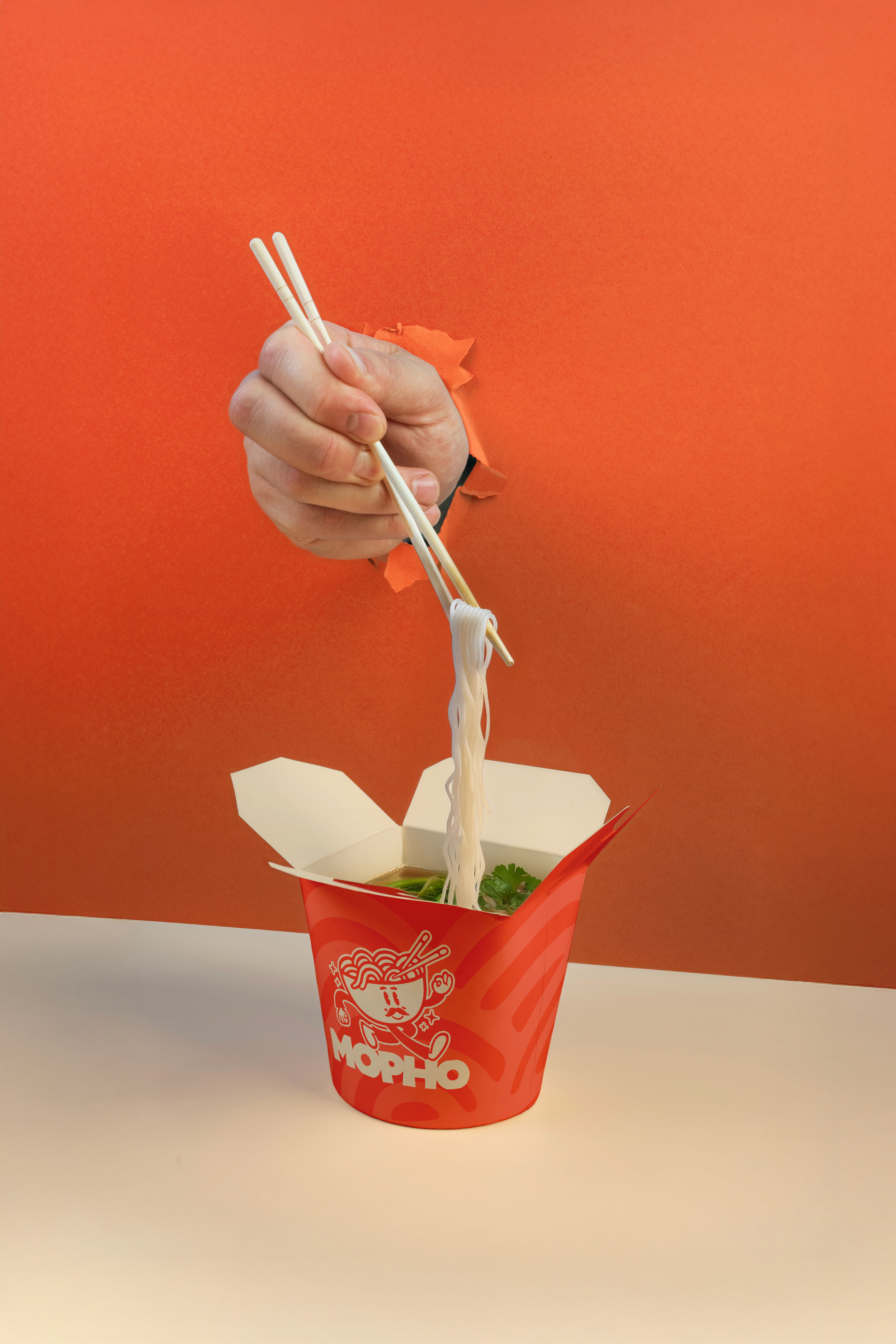 Takeaway packaging design for Mopho restaurant, showcasing clean branding and a custom illustration