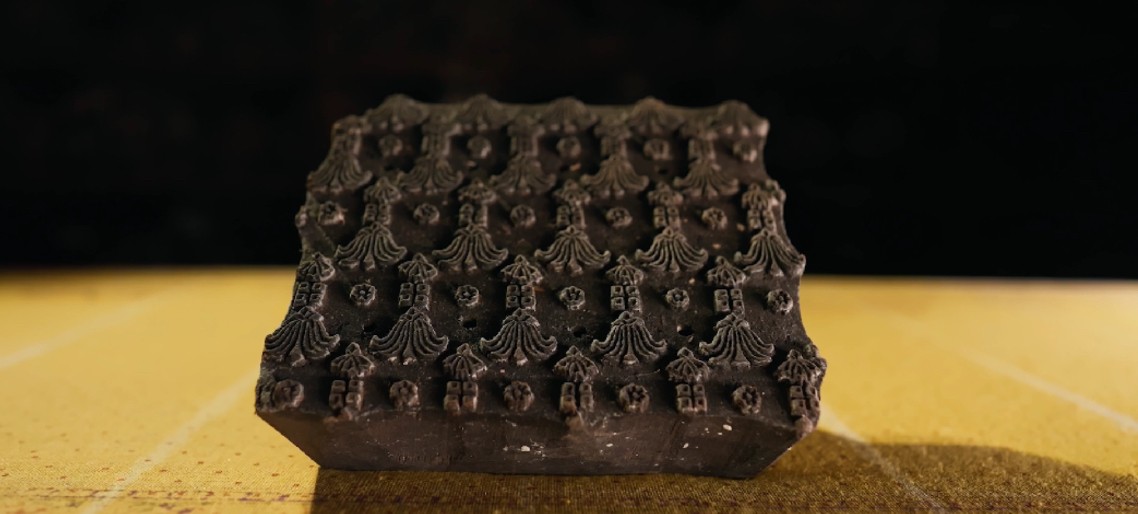 Vintage carved wooden block stamp with ornate pattern