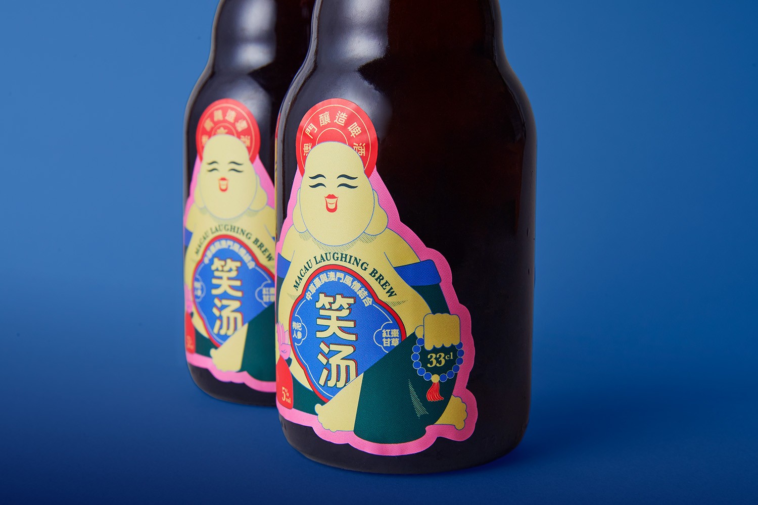 Two Macau Laughing Brew bottles displayed against a blue background.