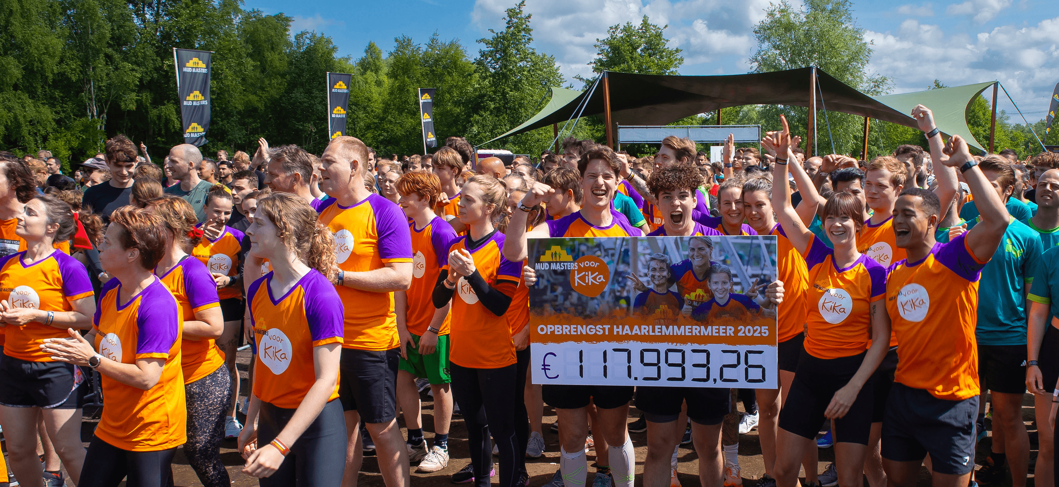 Groep deelnemers met cheque van Mud Masters voor KiKa