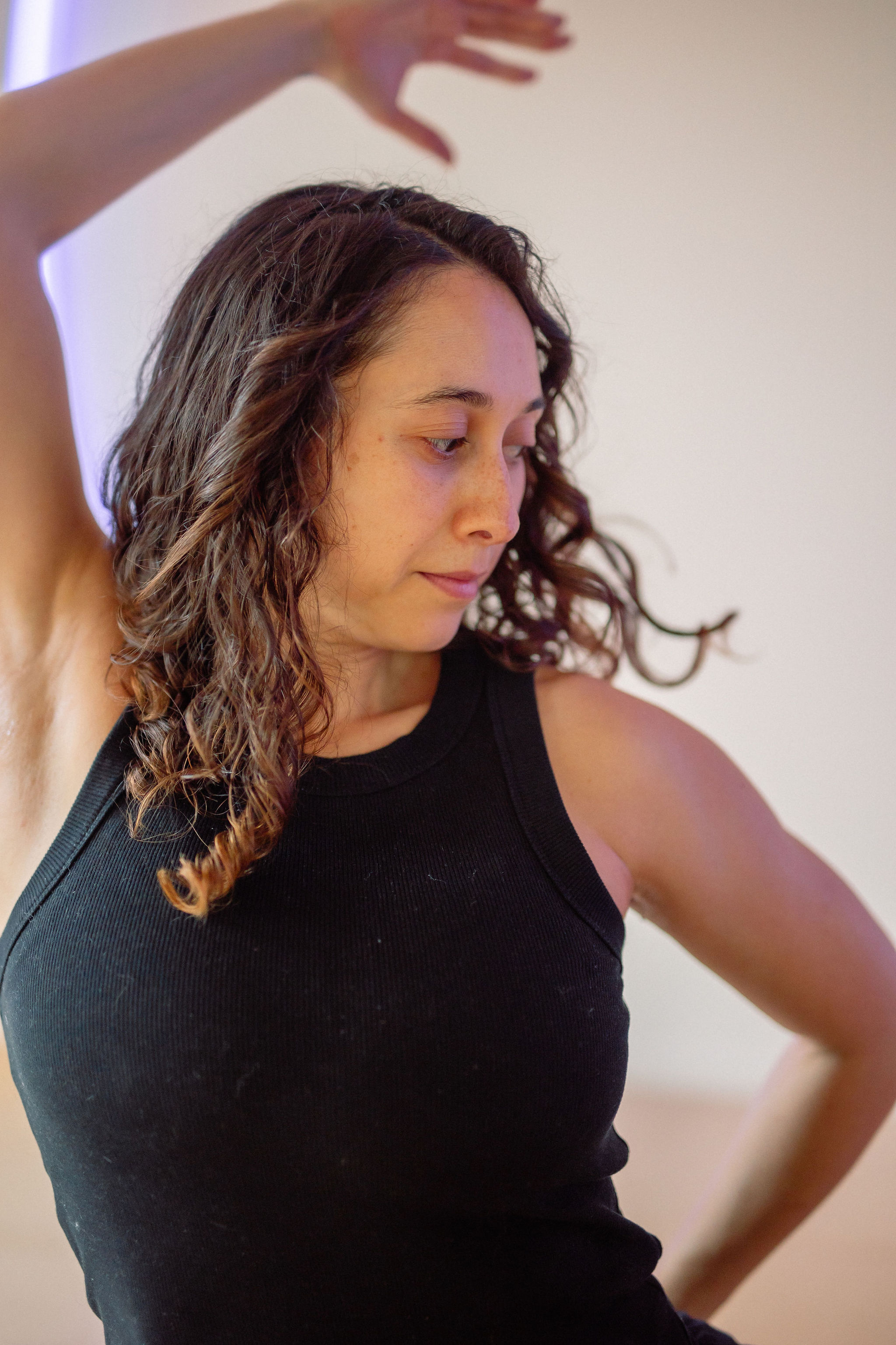 Black cosmetic product bottle against a dark background