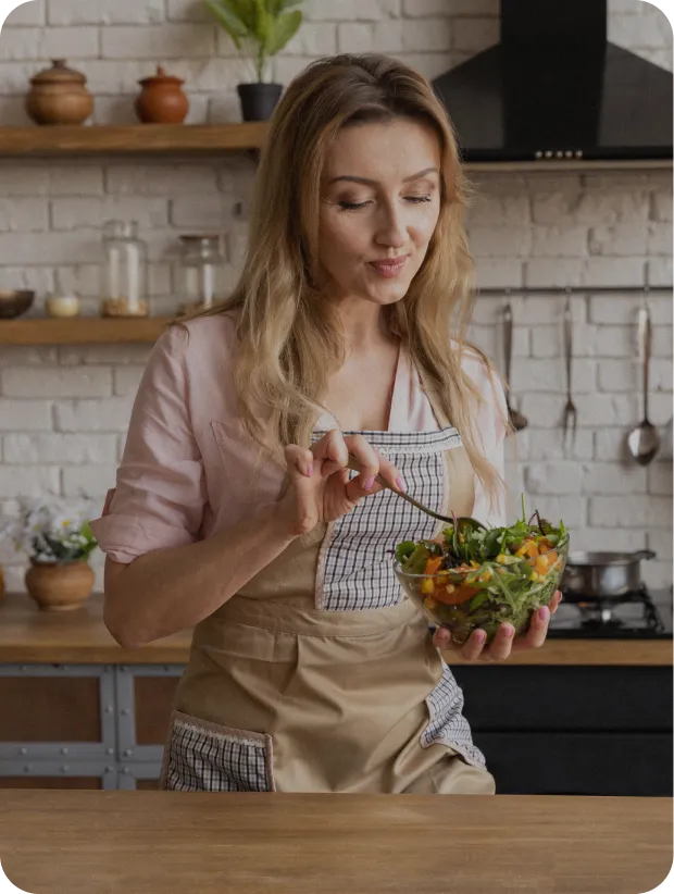 Woman standing in a kitchen with shelves in the background