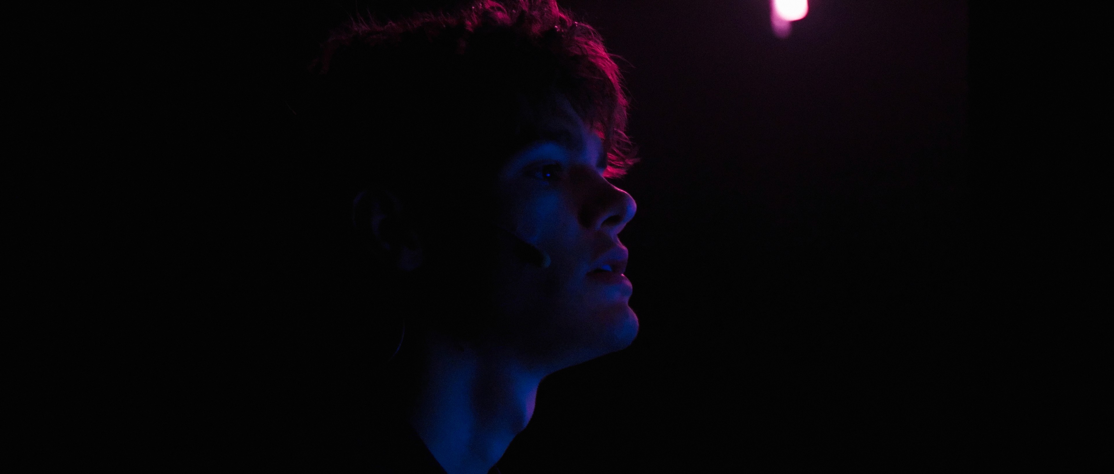Silhouette of an actor in low-key lighting, cinematography by Mateusz Kot.