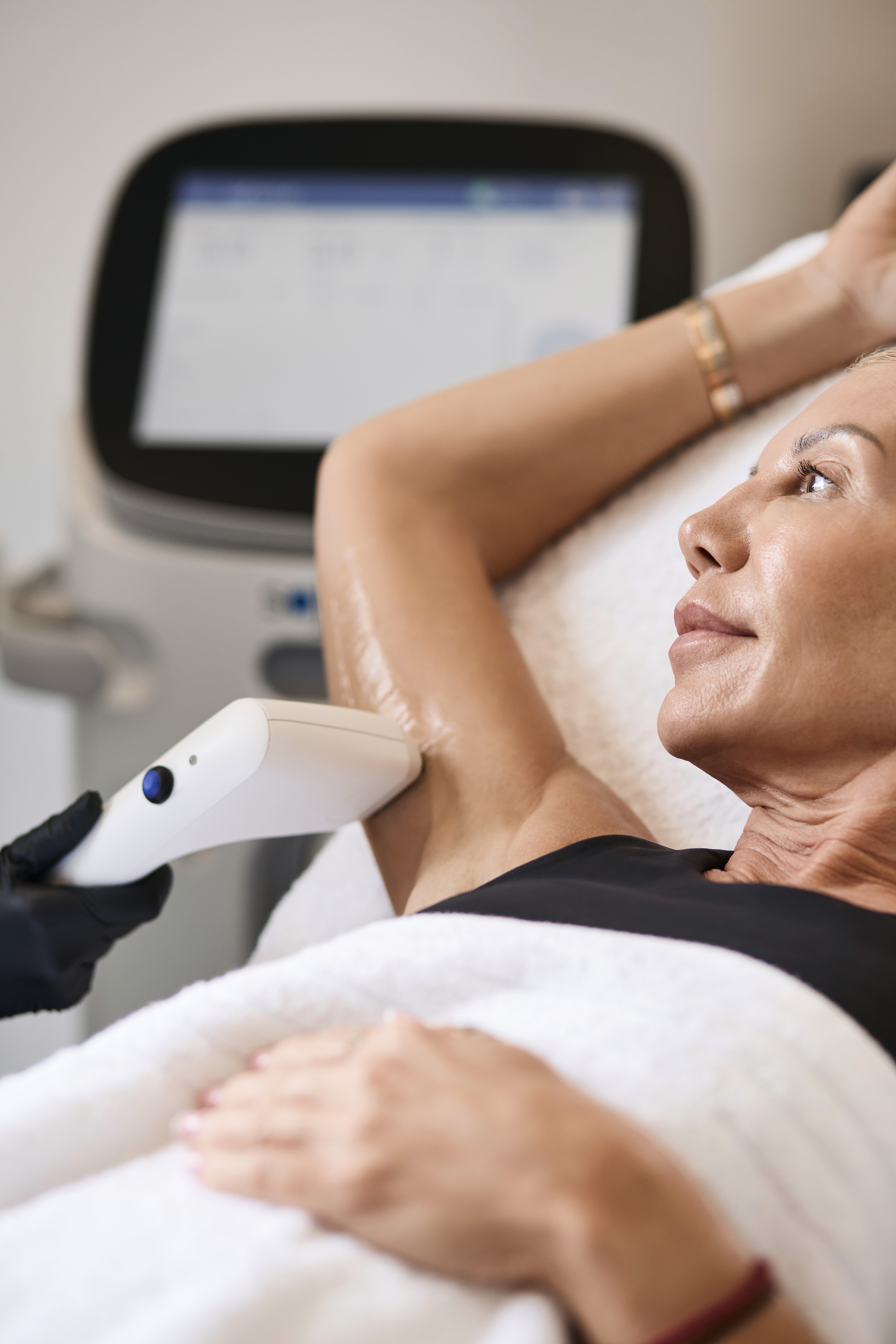 Woman having Sofwave ultrasound skin tightening treatment on her arms