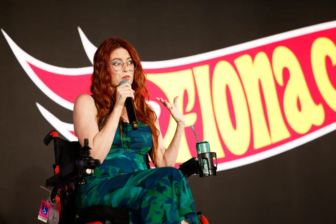 Fiona Cauley with her logo behind her