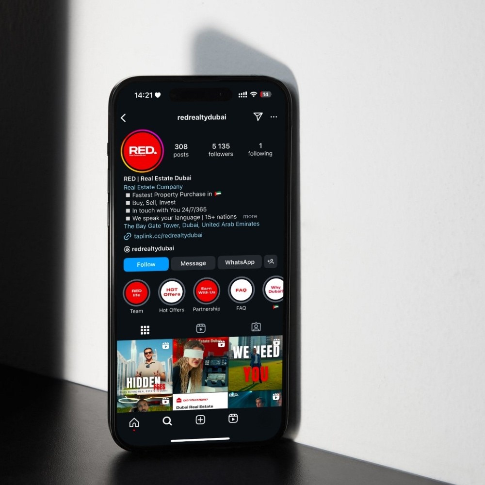 Black-and-white party photo of a smiling man in a check blazer among a crowd.
