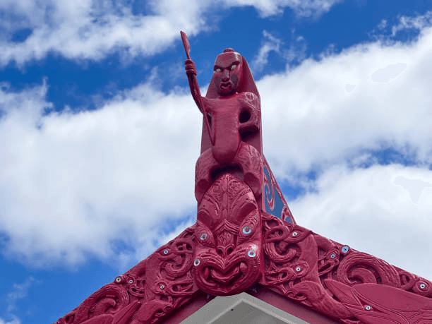 Traditional Maori marae with carved meeting house in New Zealand