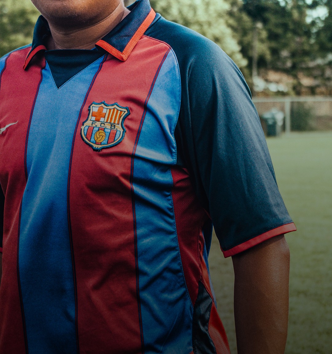 Image of hand holding retro Watford FC football shirt for KitLegit