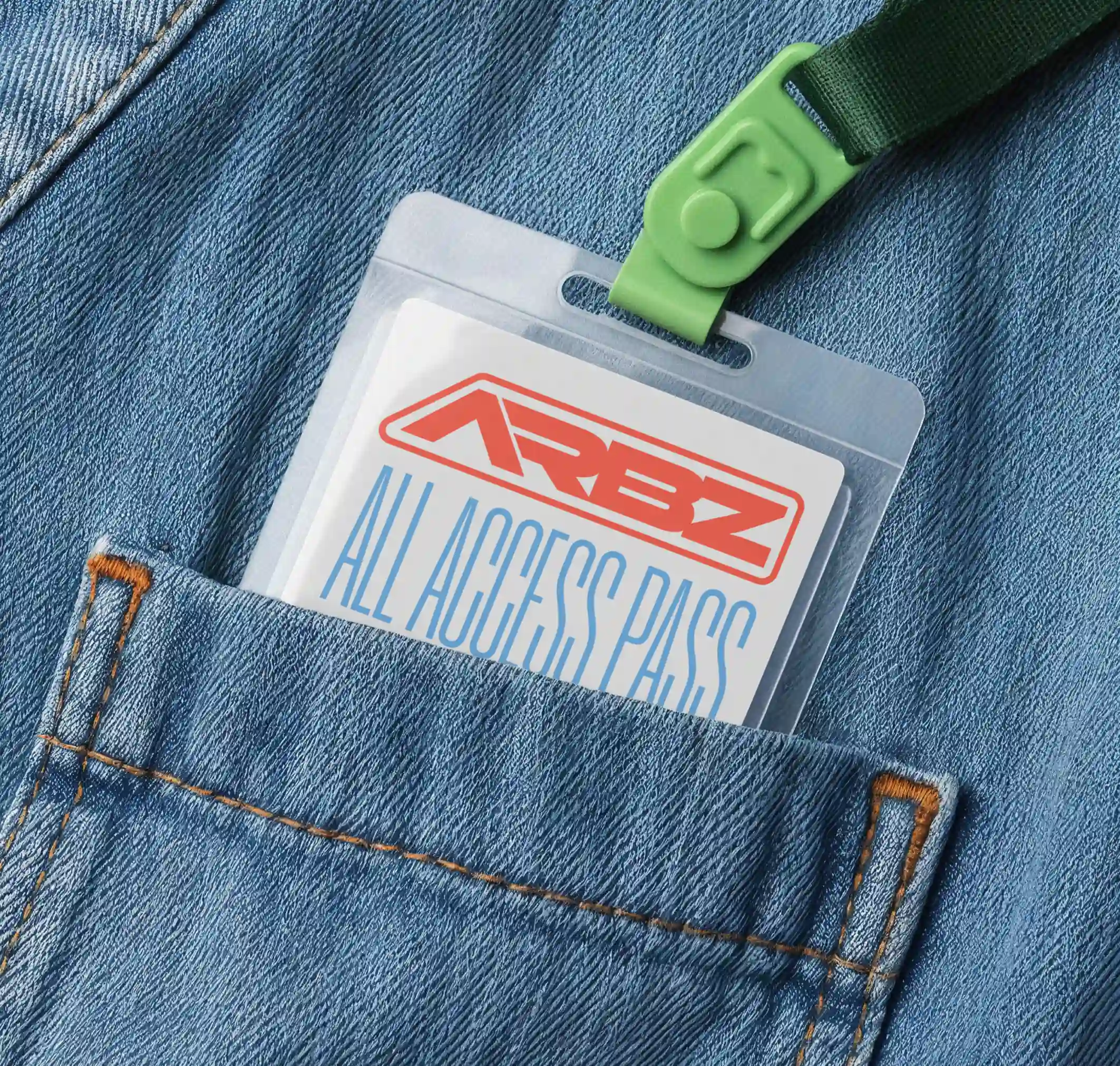 ARBZ all-access pass tucked into a denim pocket. Branded event badge with red logo and green lanyard.