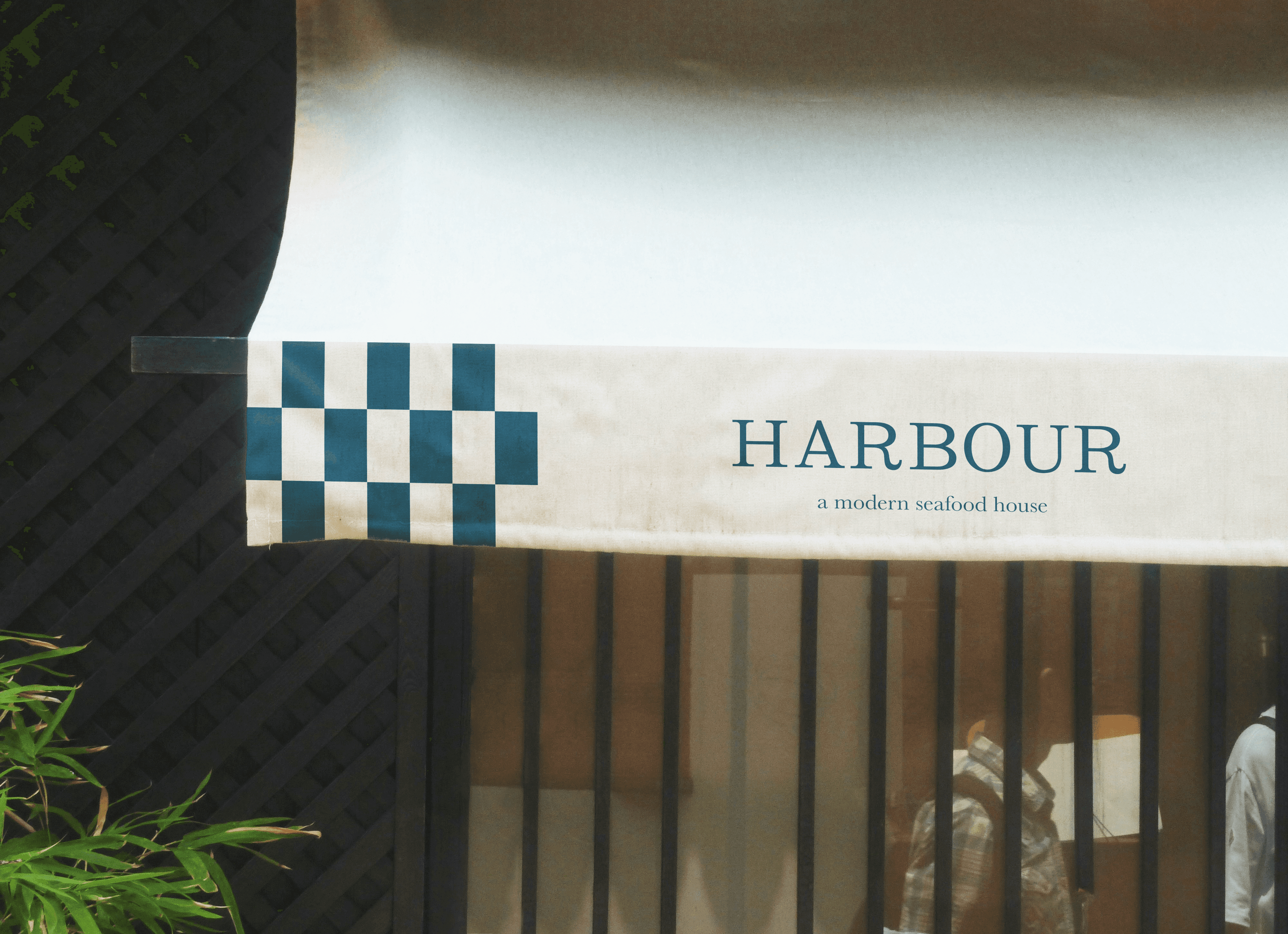 Harbour brand signage with a tiled logo outside a hospitality venue.