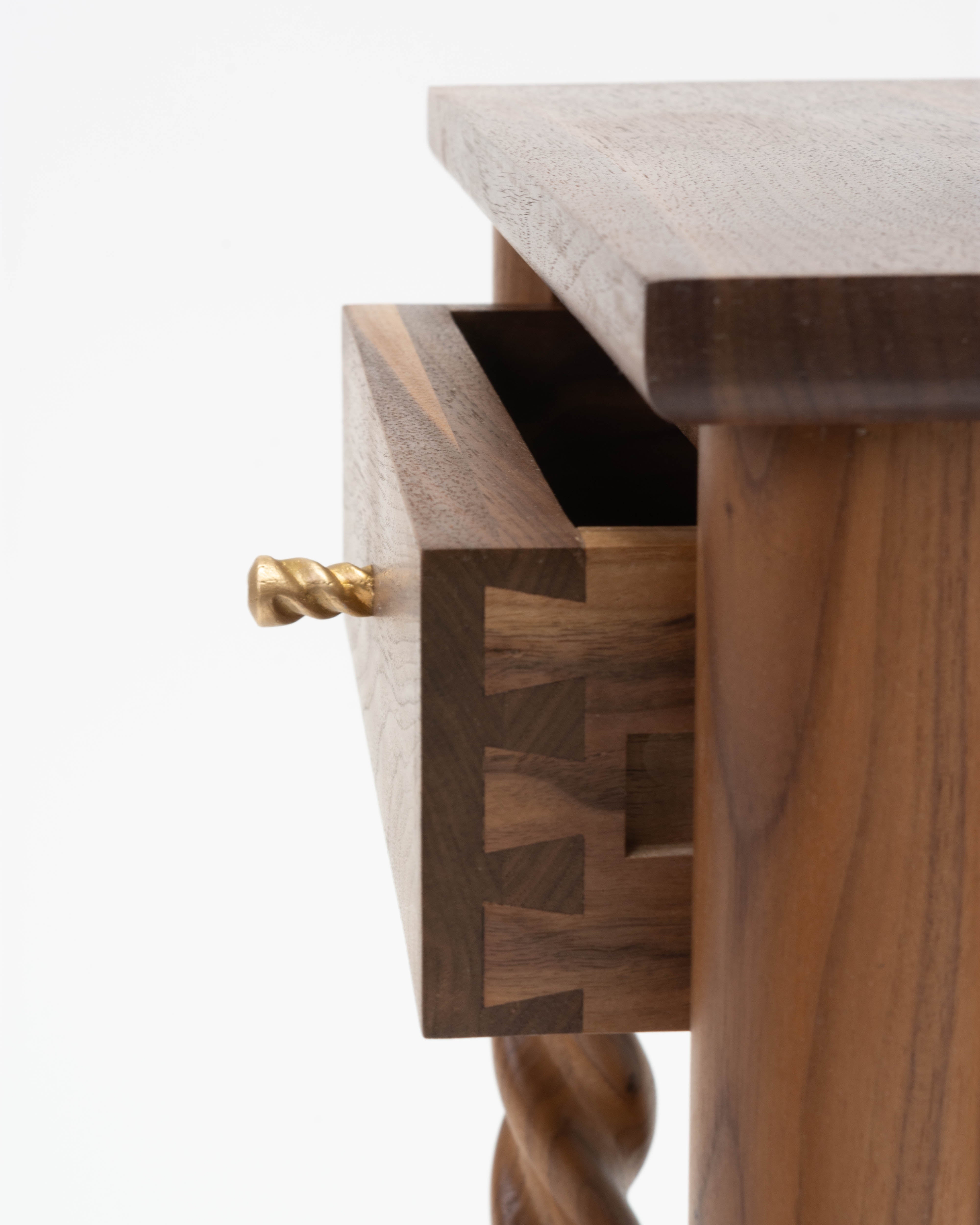Dovetail drawer with a cast bronze handle close up