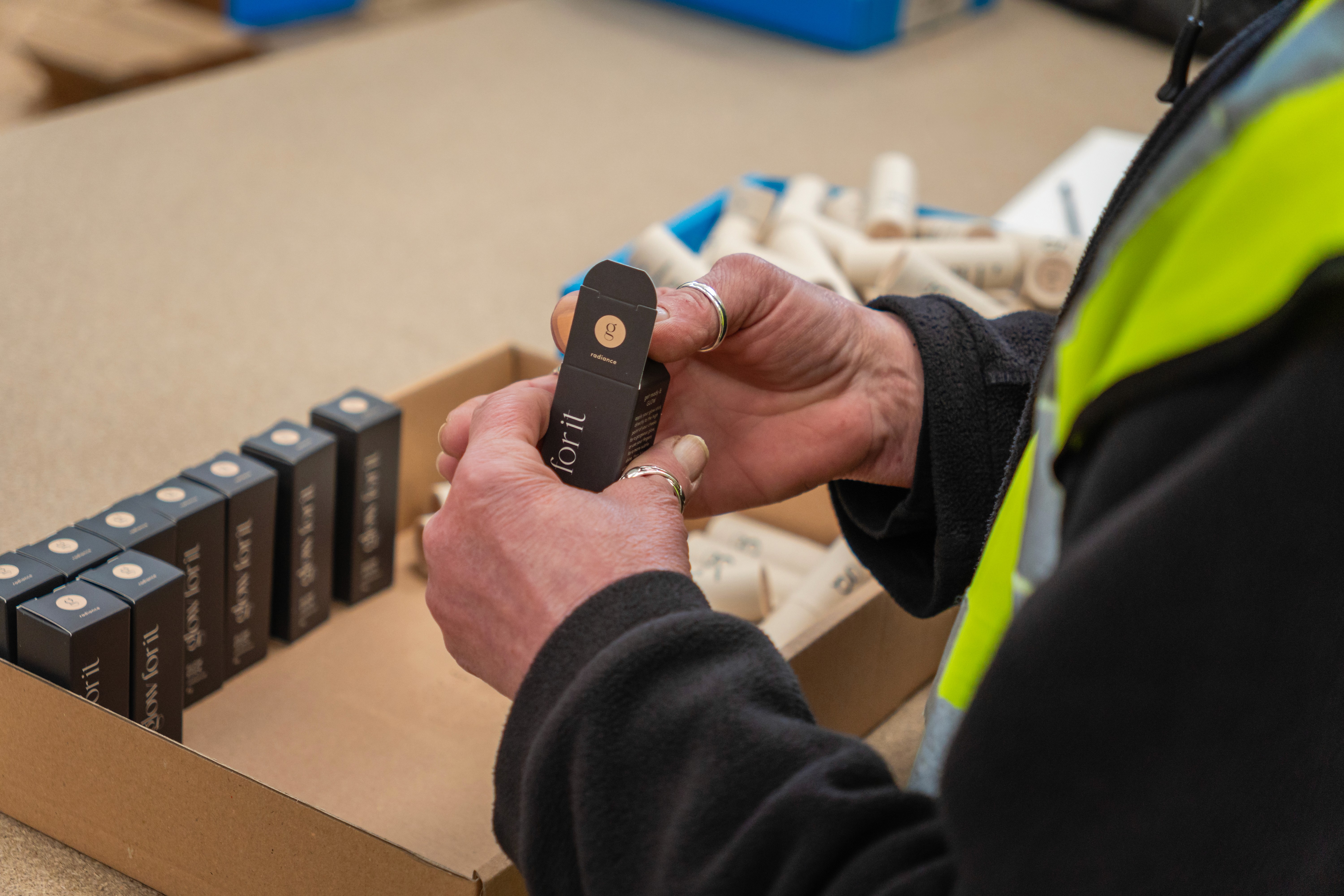 a person putting products into its packaging