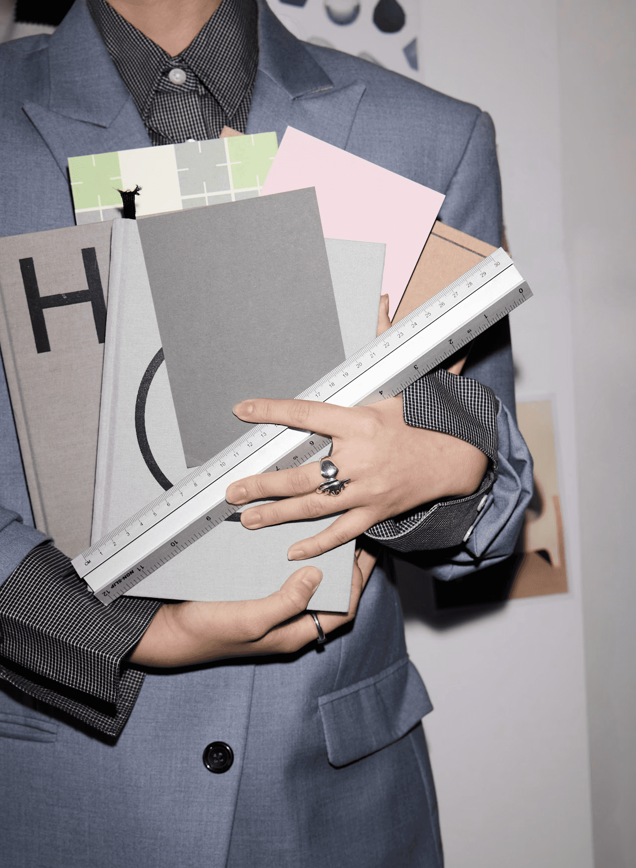 Person sitting in a modern office in front of a wall covered with notes and sketches.