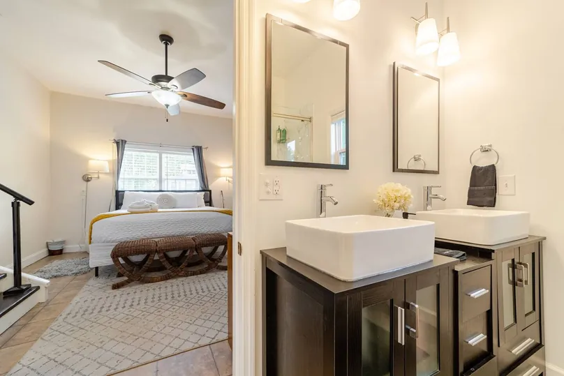 Double vanity with vessel sinks in the en-suite of the stepped-down suite