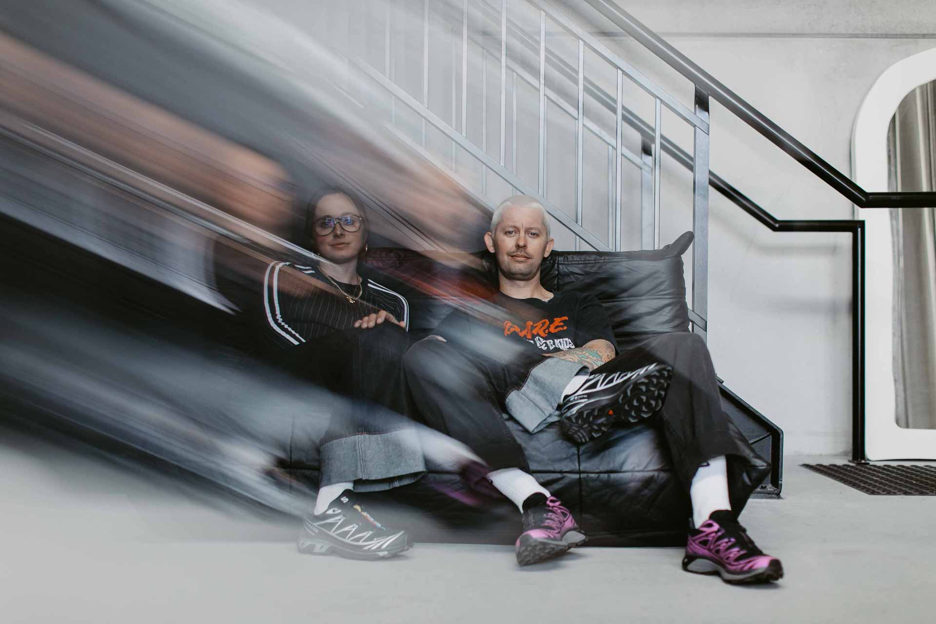 Alice and Rhys sitting on a couch