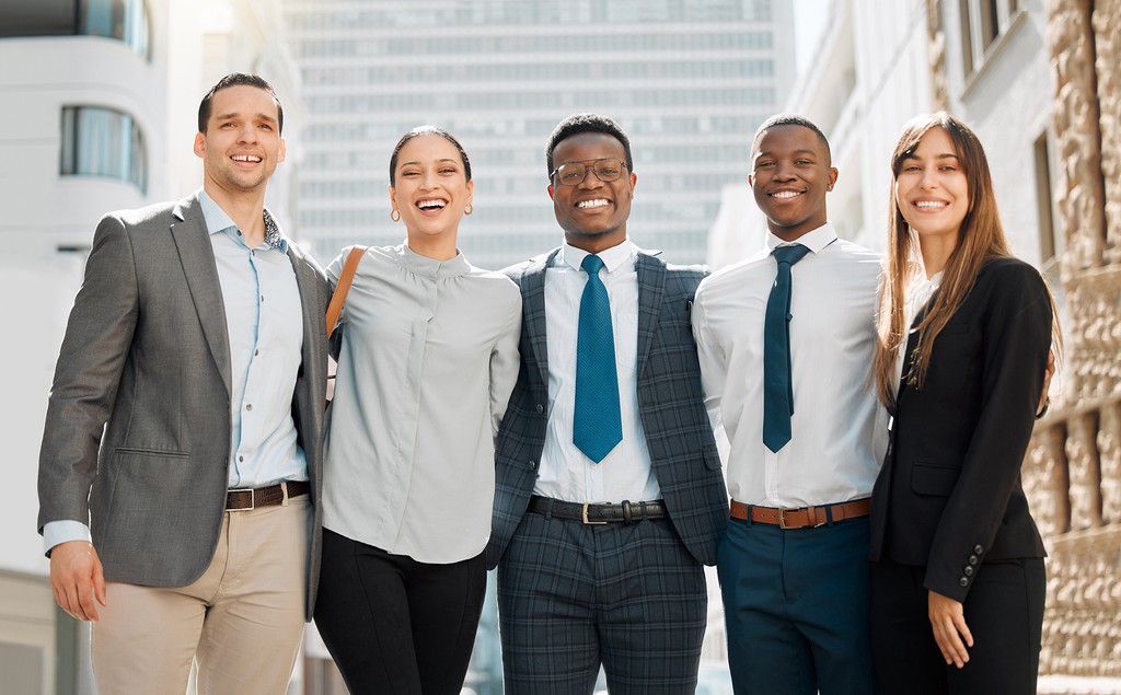 man standing in front of people sitting beside table with laptop computers