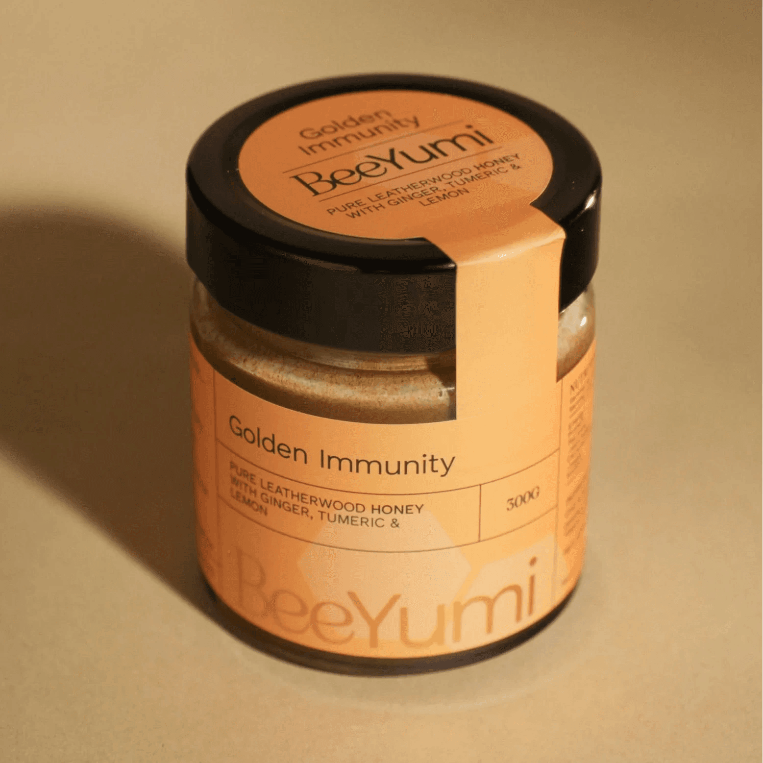 Jar of BeeYumi Golden Immunity on a beige background