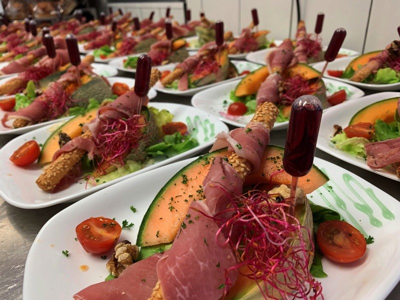 Modern bathroom featuring wooden cabinetry, a bathtub, a sleek sink, and natural light from a window.
