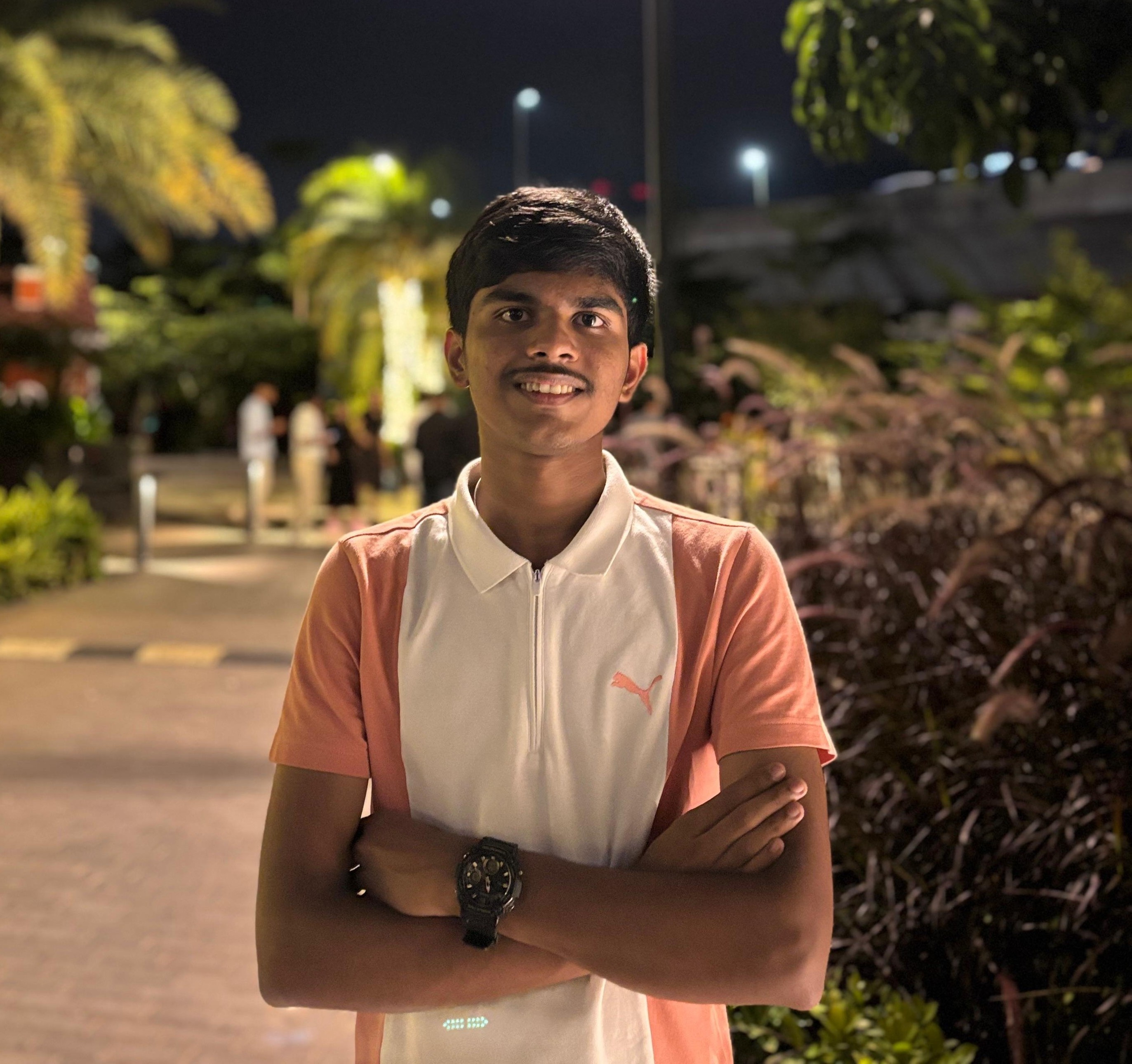 a man wearing glasses and a blazer with a lighting that casts a soft shadow on the wall behind him