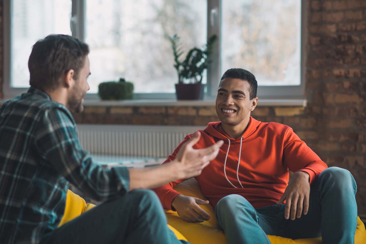 	Two people talking on a sofa during a support session