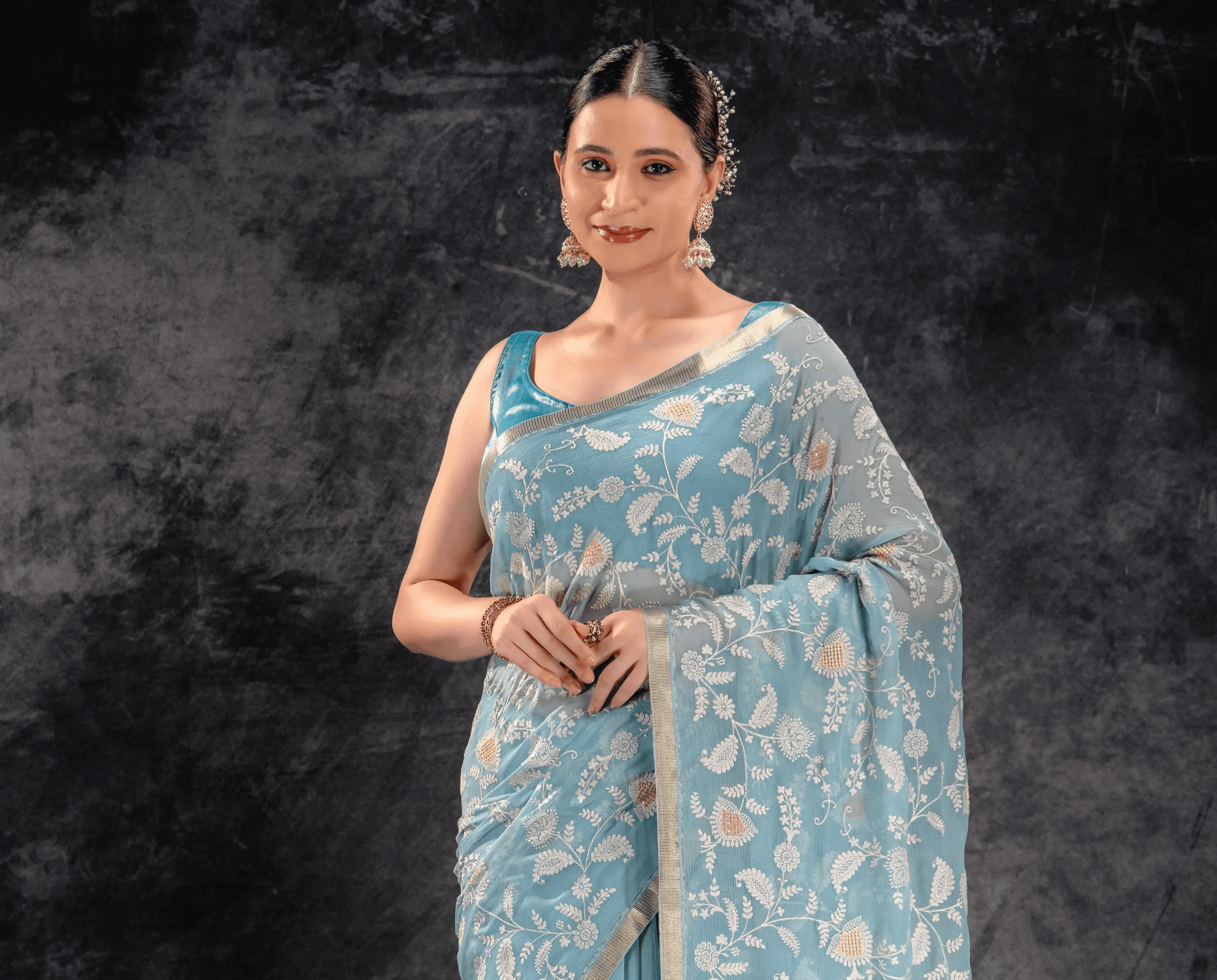 A woman wearing Dusty Aqua Embroidered Chiffon Saree