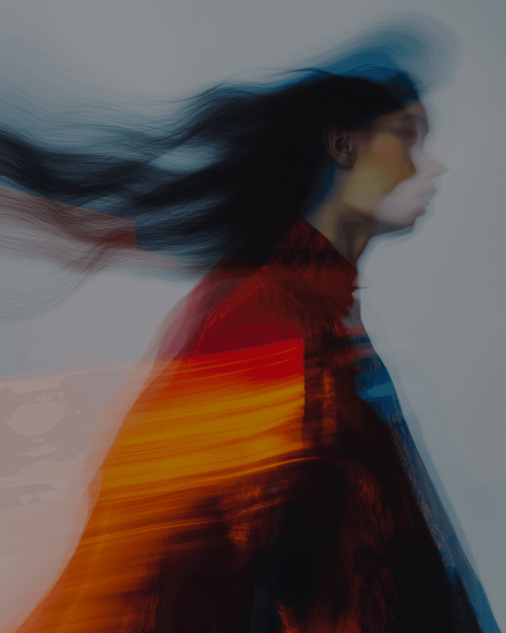 Artistic portrait of a person with light skin and glasses, featuring a blurred effect for an intriguing look.