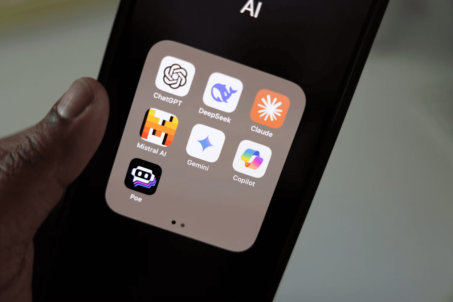 Smartphone showing a folder of AI assistant apps used for workflow automation