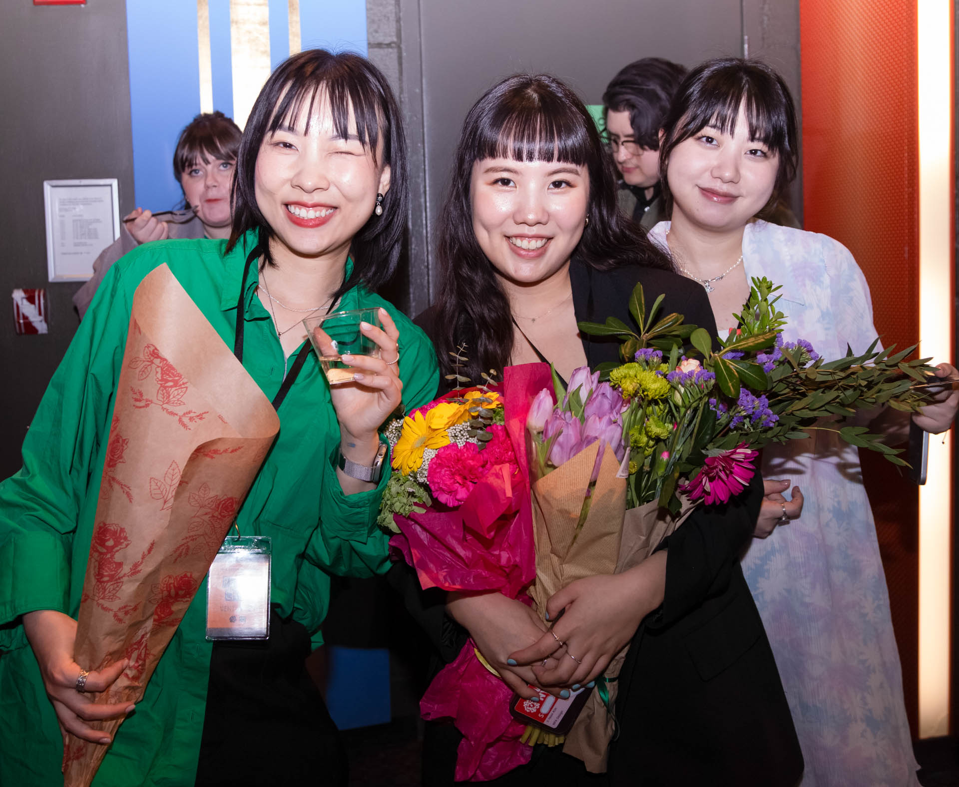 a group of students smiling for the camera in the SVA Theatre lobby after the Venture Forum