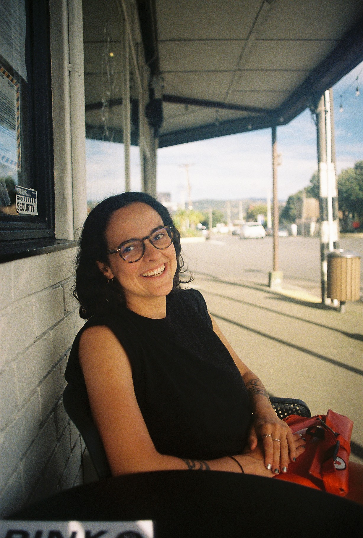 A very happy Maria waiting for her food at a restaurant
