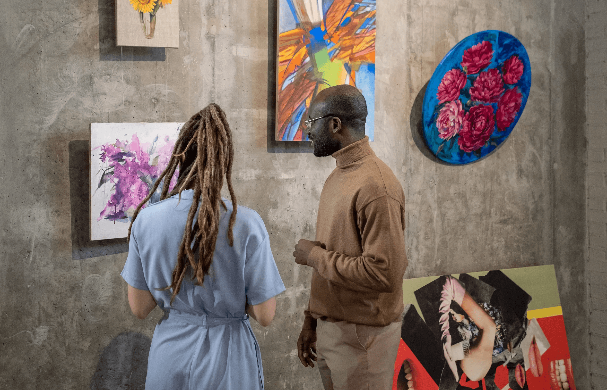 Two residents viewing artwork at the Cocoon 121 community art gallery.