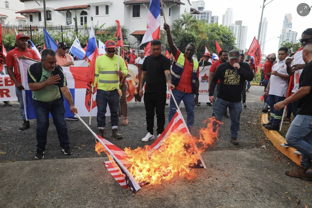 People burn American flags during an anti-Trump protest in Panama City, Panama.