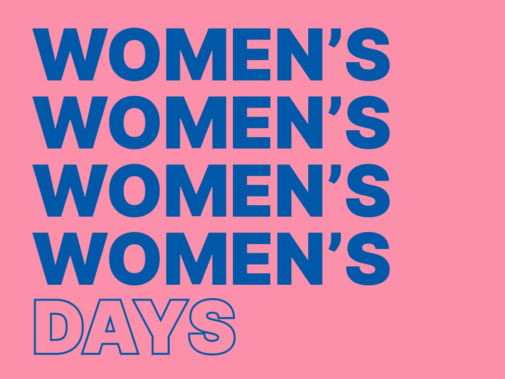 woman holding a phone and man looking at the phone. both are smiling