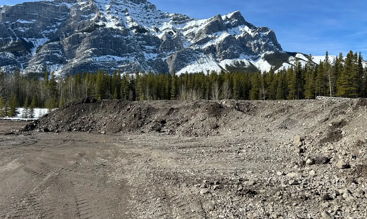 Mobile crushing and screening plant processing granular material at a Storage Yard in Kananaskis, Alberta
